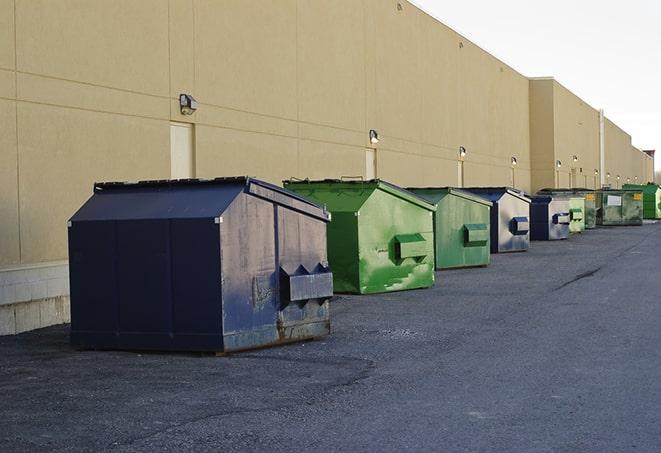 big yellow dumpsters on a construction lot in Aurora